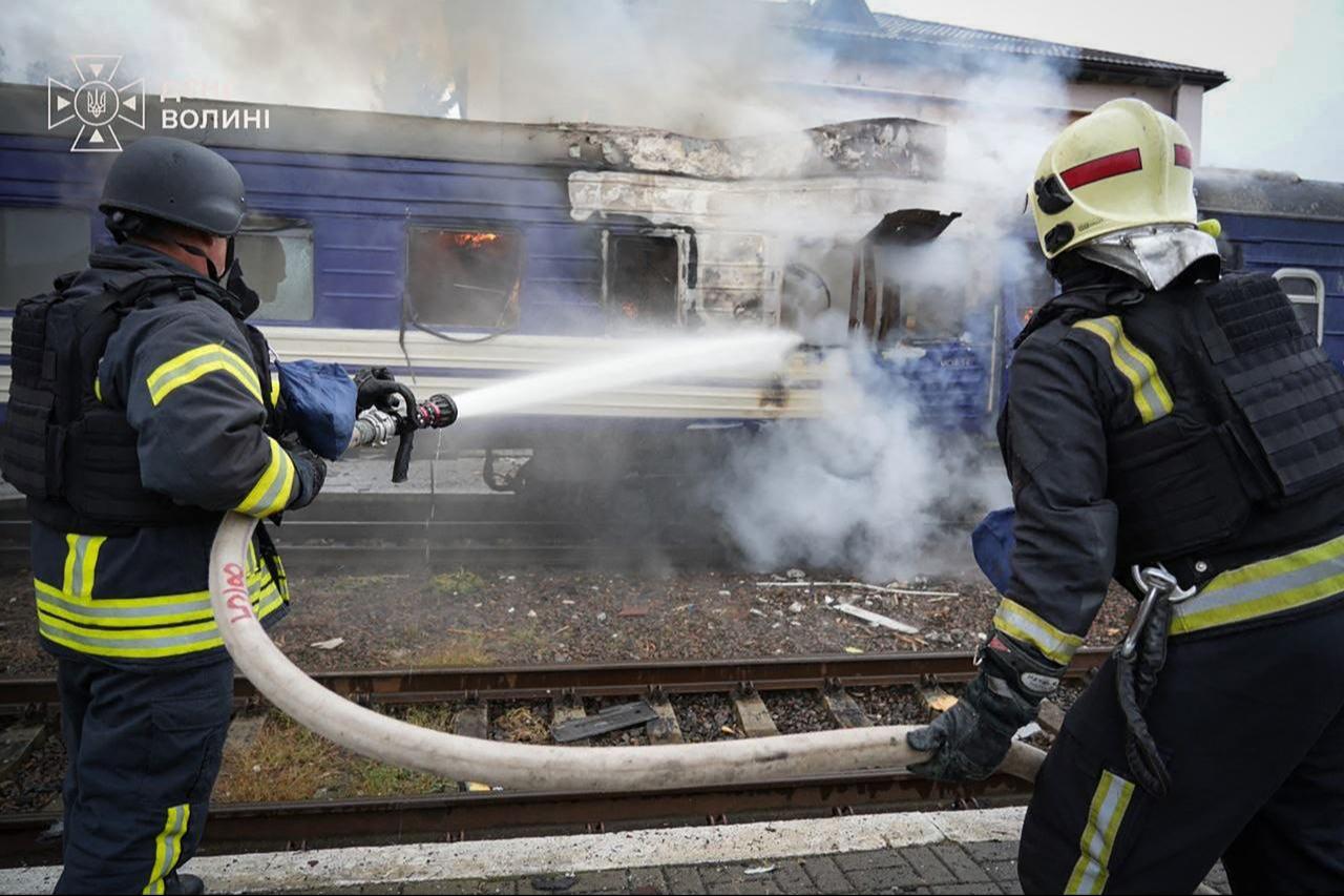 This handout picture taken and released on September 13, 2026 shows firefighters spraying water at a train carriage damaged by a drone strike near the border with Poland. (AFP Photo/Handout/Ukrainian State Emergency Service)