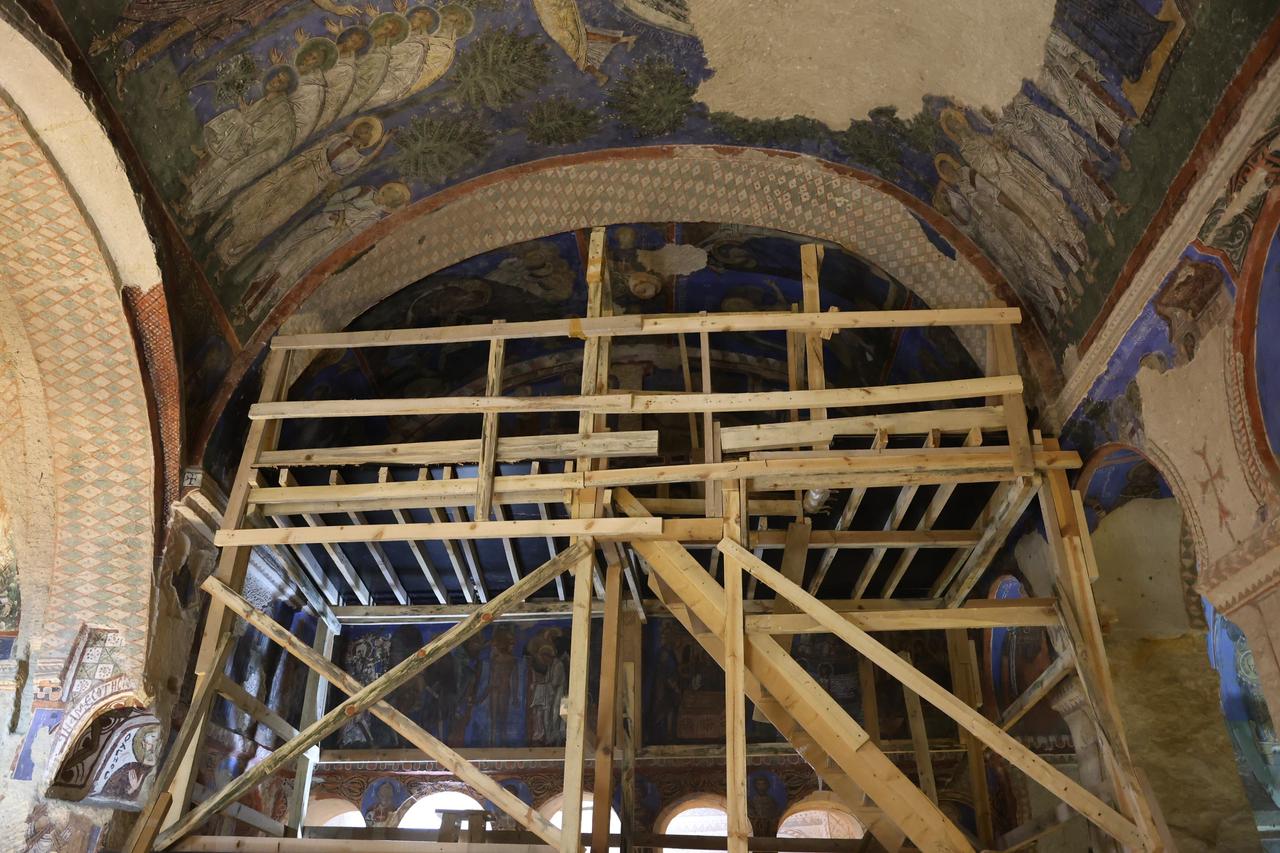 Conservation structures are set up beneath historic wall paintings inside a cultural heritage site in Cappadocia. (IHA Photo)