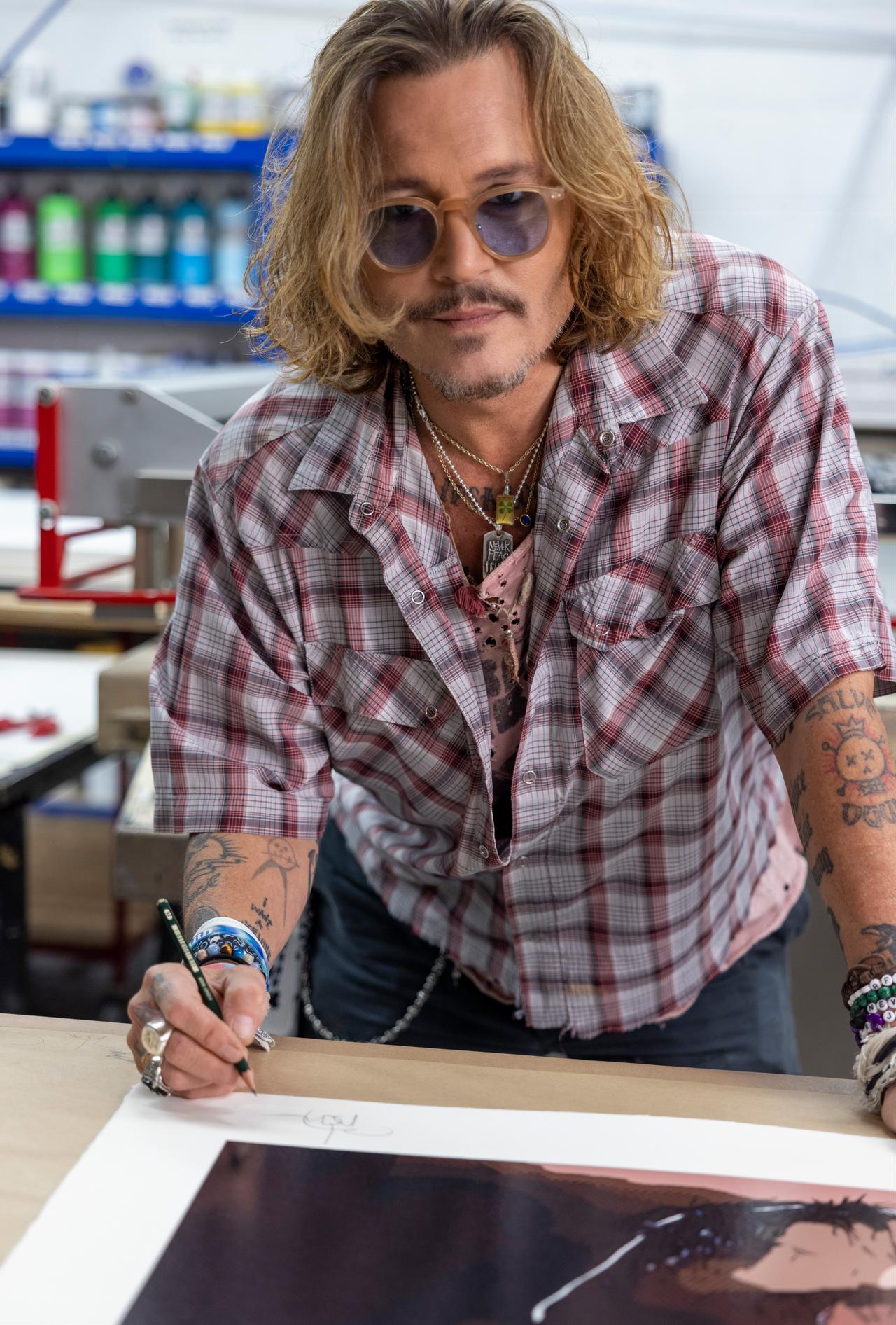 Johnny Depp works on one of his visual art pieces. (Photo courtesy of Sigg Art Foundation)