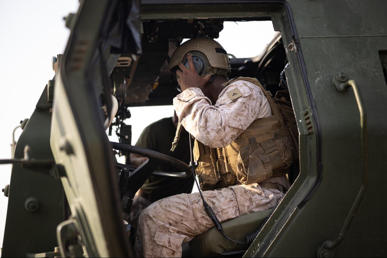 A U.S. Marine dons a Combat Vehicle Crewman helmet during a High Mobility Artillery Rapid Insertion class in the U.S. Central Command area of responsibility, Sept. 10, 2026. (Photo via U.S. Marine Corps)