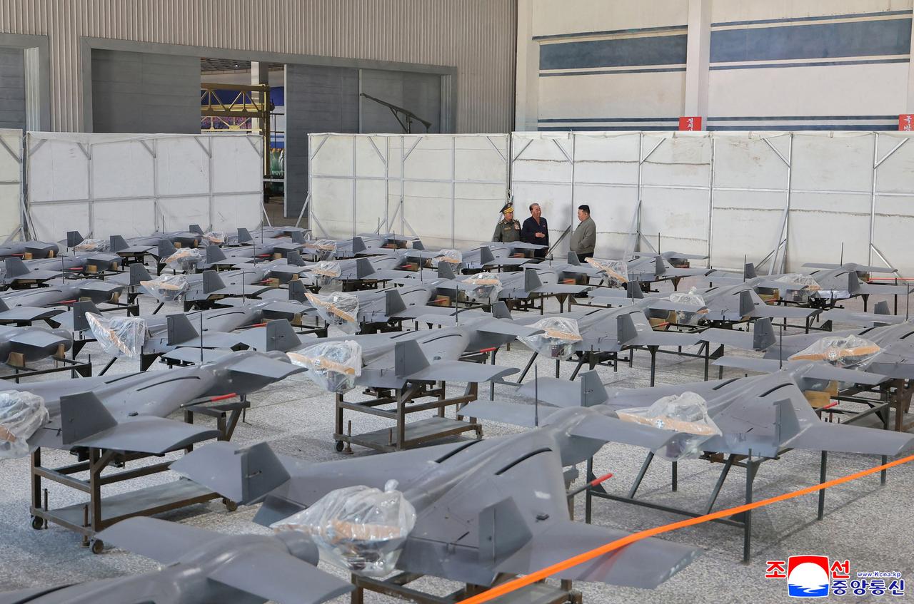 This undated photo taken between September 16-18, 2026 and released by North Korea's official Korean Central News Agency (KCNA) on September 19, 2026 shows North Korean leader Kim Jong Un (background R) inspecting drones at a munitions factory in an undiclosed location in North Korea. (Photo by KCNA / KCNA VIA KNS / AFP)