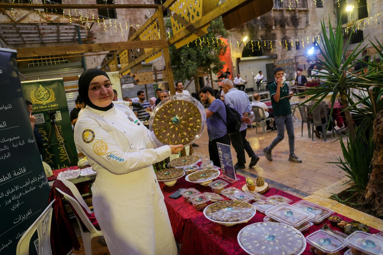 A woman shows a tray during Syria's first pistachio festival is held at the historic Silk Market in Aleppo, Syria, on September 18, 2026. (AA Photo)