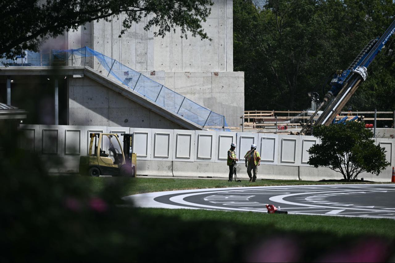 Work continues on the new helipad (foreground) and East Wing ballroom (background), as seen on the South Lawn of the White House in Washington, DC, Sept. 15, 2026. (AFP Photo)