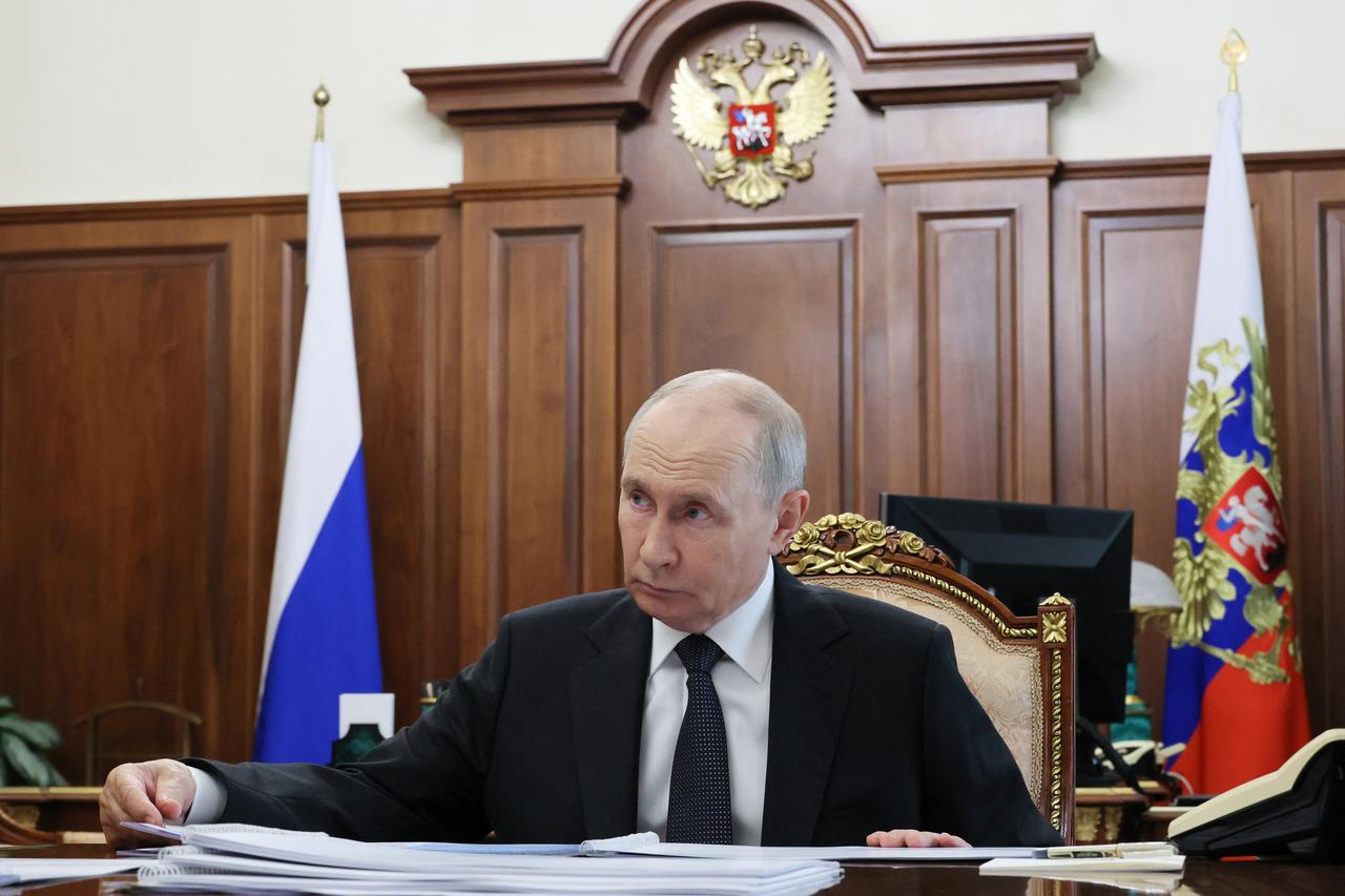 In this pool photograph distributed by the Russian state agency Sputnik, Russia's President Vladimir Putin attends a meeting with the governor of Novgorod region in Moscow on September 14, 2026. (Photo by Sputnik / AFP)