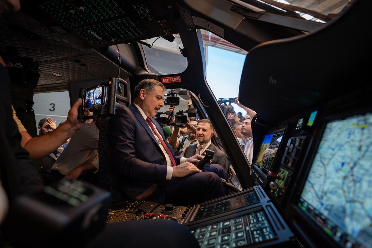 Türkiye's Interior Minister Mustafa Ciftci inspects the cockpit of a T625 GOKBEY helicopter during the first delivery ceremony to the General Directorate of Security at Turkish Aerospace Industries (TAI) facilities in Kahramankazan, Ankara, Türkiye, Sept. 2, 2026. (AA Photo)