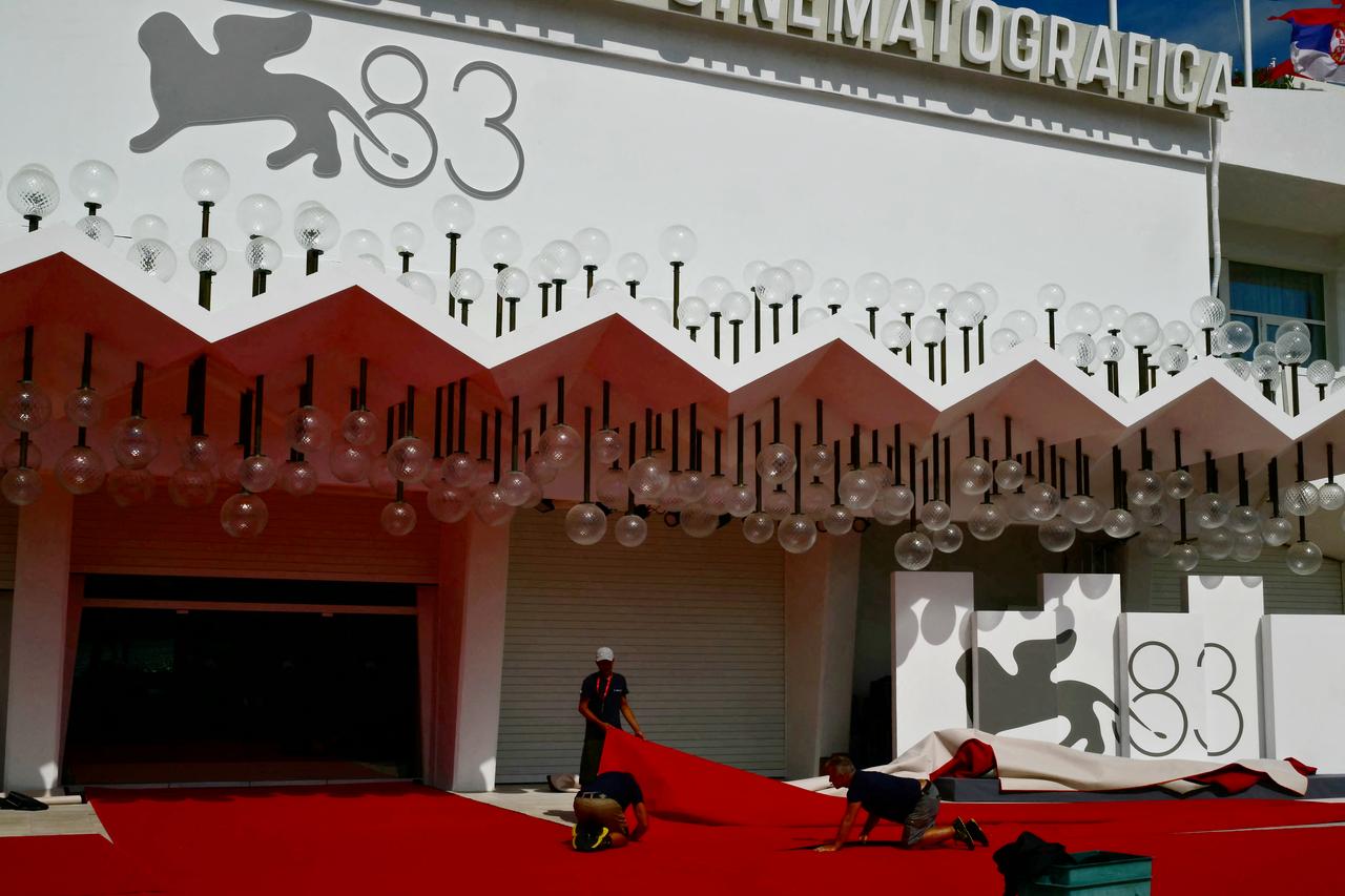 Workers arrange the red carpet outside the main festival venue during preparations for the 83rd Venice International Film Festival on the Lido in Venice, Italy, Sept. 1, 2026. (AFP Photo)