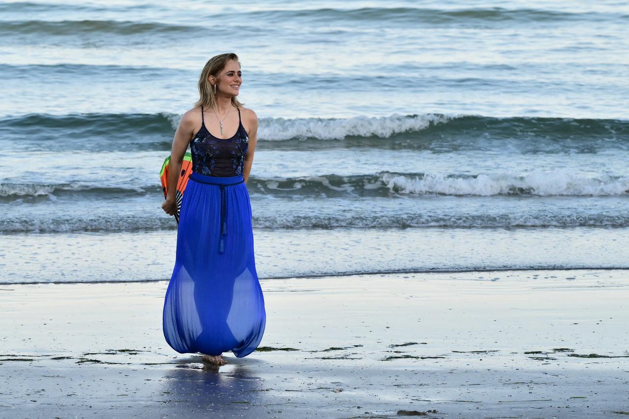A woman poses on the beach during the 83rd Venice International Film Festival on the Lido in Venice, Italy, Sept. 1, 2026. (AFP Photo)