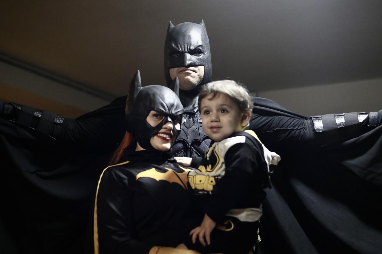 Fans wearing Batman-themed costumes pose with a child during celebrations marking the superhero’s 87th anniversary in Lima, Peru, Sept. 20, 2026. (AA Photo)
