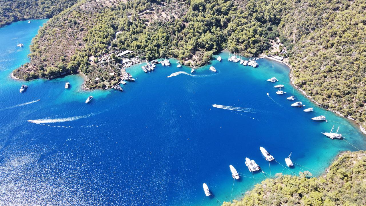 An aerial view of Bedri Rahmi Bay in Mugla, showing boats anchored in the clear turquoise waters. (AA Photo)