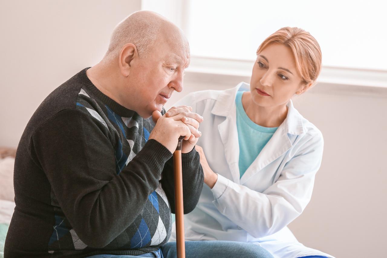 An older man speaks with a health care professional during a consultation. (Adobe Stock Photo)