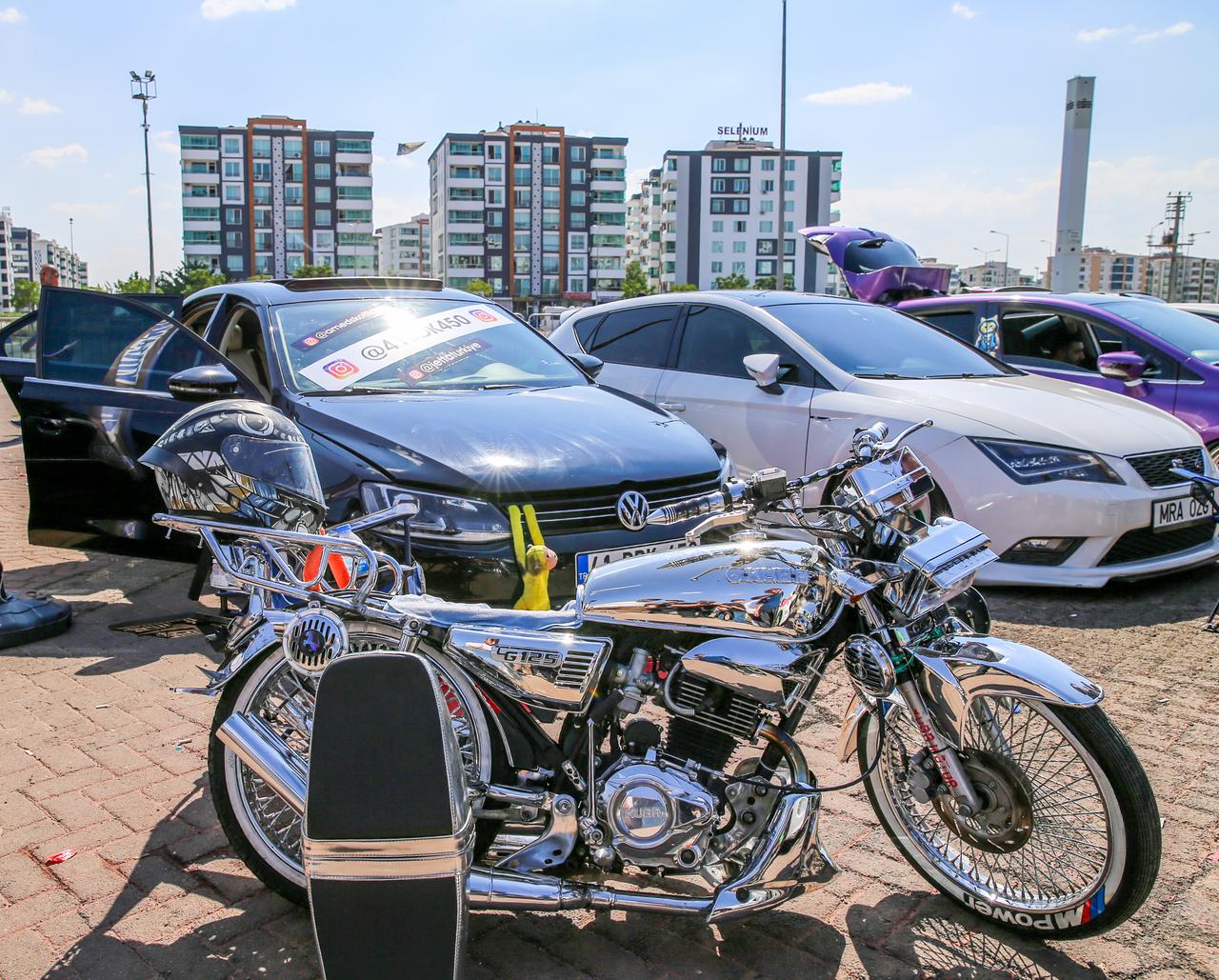 A customized motorcycle and modified cars are displayed during an automobile festival in Diyarbakir, Türkiye, Sept. 20, 2026. (AA Photo)