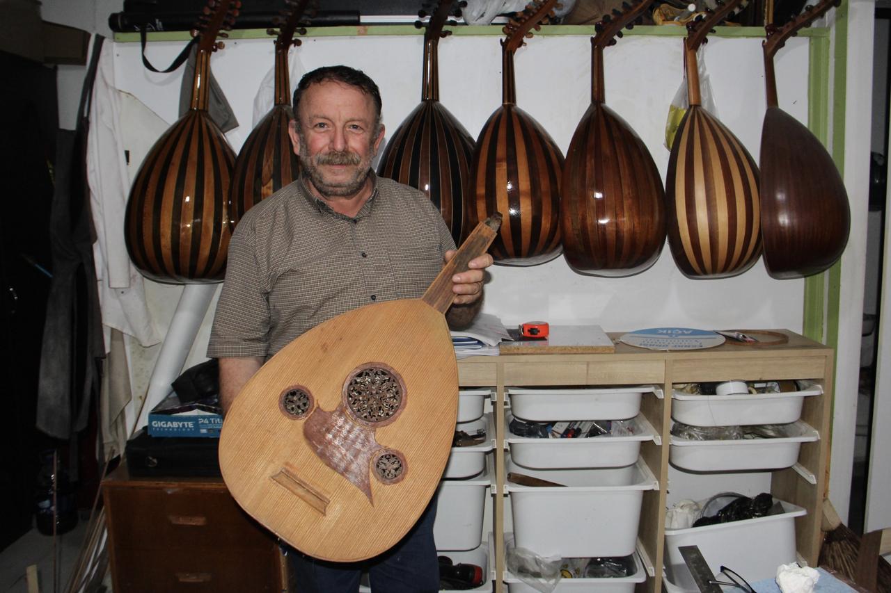 Ibrahim Kocabıyık displays a handmade oud at his workshop in Türkiye, Sept. 20, 2026. (AA Photo)