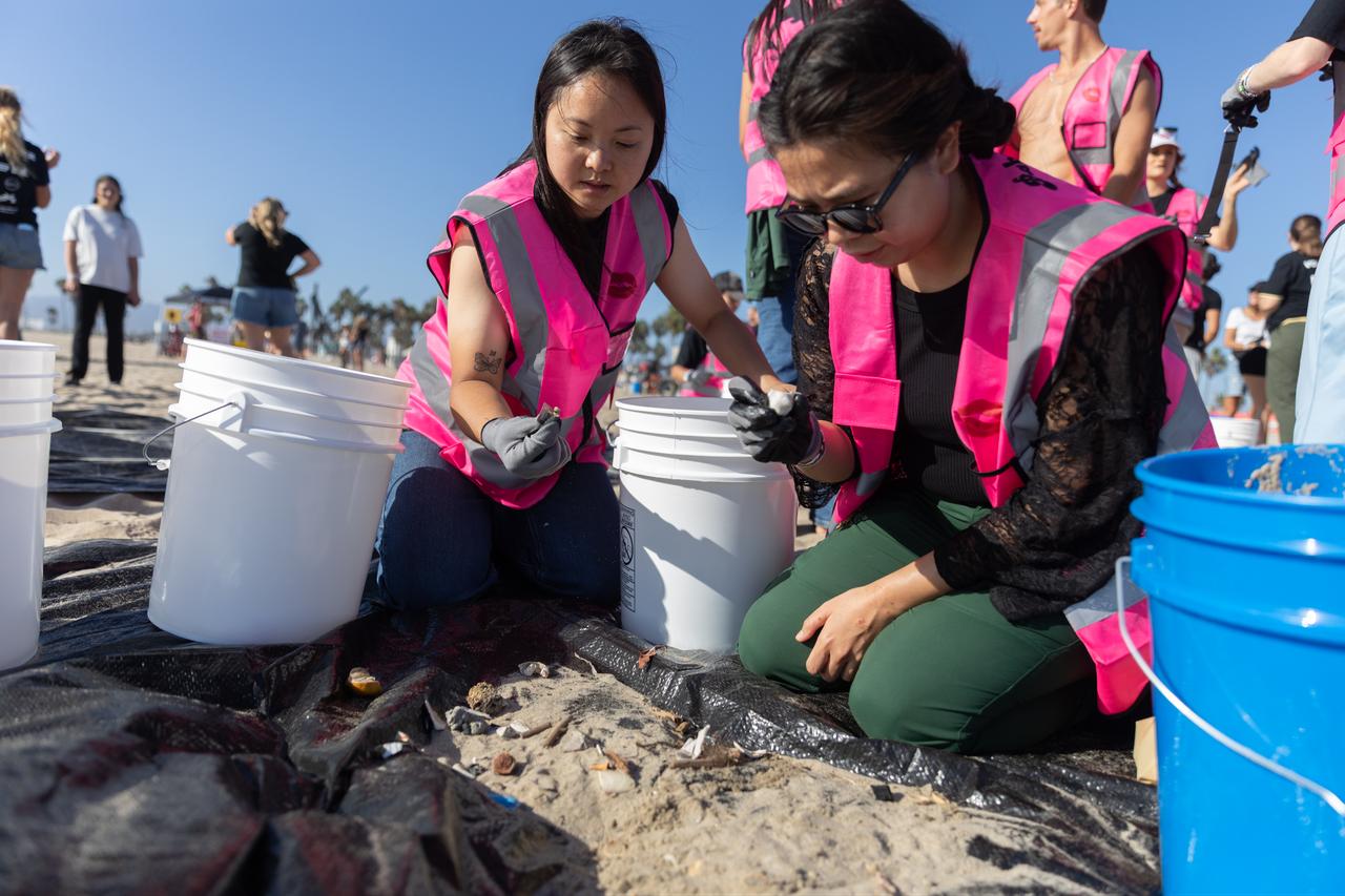 Volunteers sort debris collected during a beach cleanup organized for a Guinness World Record attempt at Venice Beach in Los Angeles, California, Sept. 20, 2026. (AA Photo)