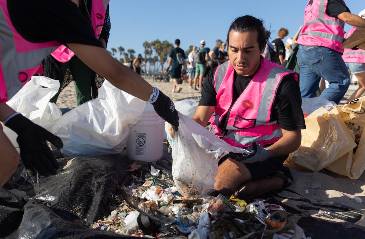 Volunteers sort debris collected during a beach cleanup organized for a Guinness World Record attempt at Venice Beach in Los Angeles, California, Sept. 20, 2026. (AA Photo)
