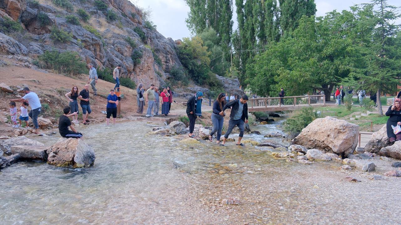 Visitors cool off in the cold spring water surrounding the Ivriz cultural landscape in Halkapinar, Konya, Türkiye. (IHA Photo)