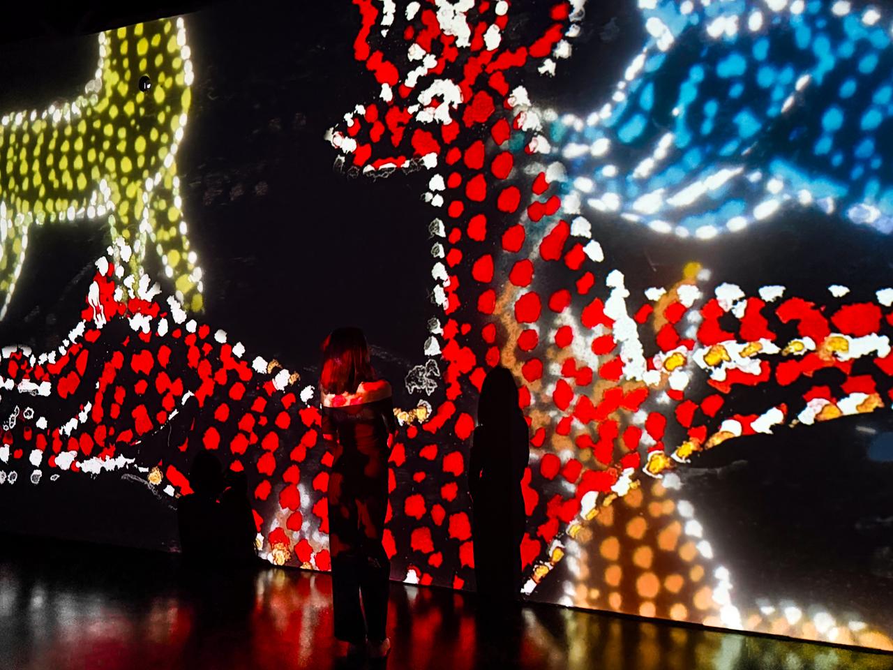 Visitors stand before digitally reimagined works by Turkish painter and poet Bedri Rahmi Eyuboglu at CerModern's Flow Digital Stage in Ankara, Türkiye. (AA Photo)