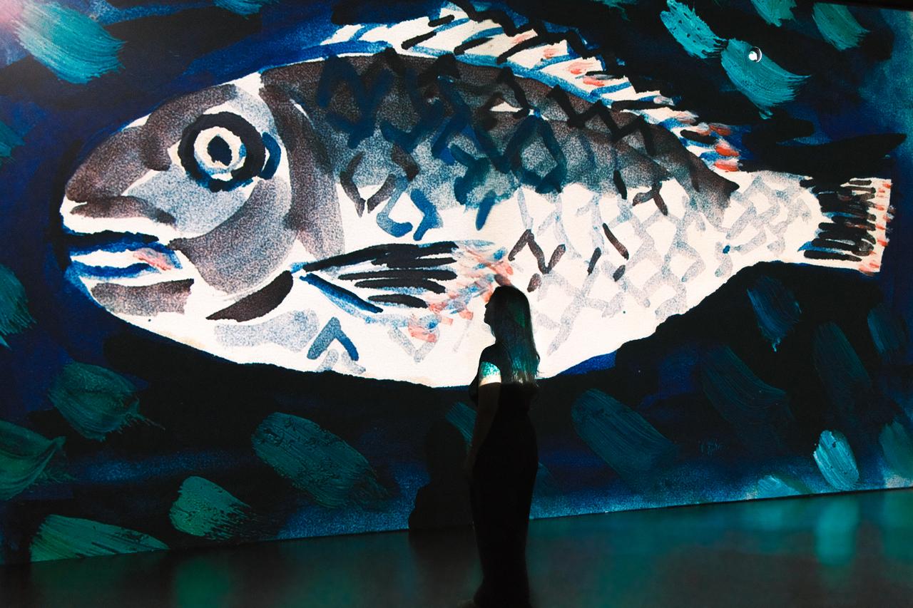 A visitor stands before digitally reimagined works by Turkish painter and poet Bedri Rahmi Eyuboglu at CerModern's Flow Digital Stage in Ankara, Türkiye. (AA Photo)