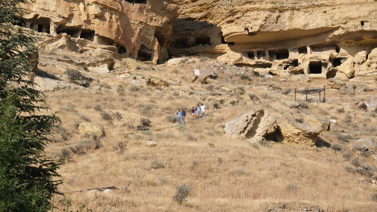 Visitors explore the five-level Manazan Caves, carved by hand into a massive rock formation in Taskale village, Karaman, Türkiye. (IHA Photo)
