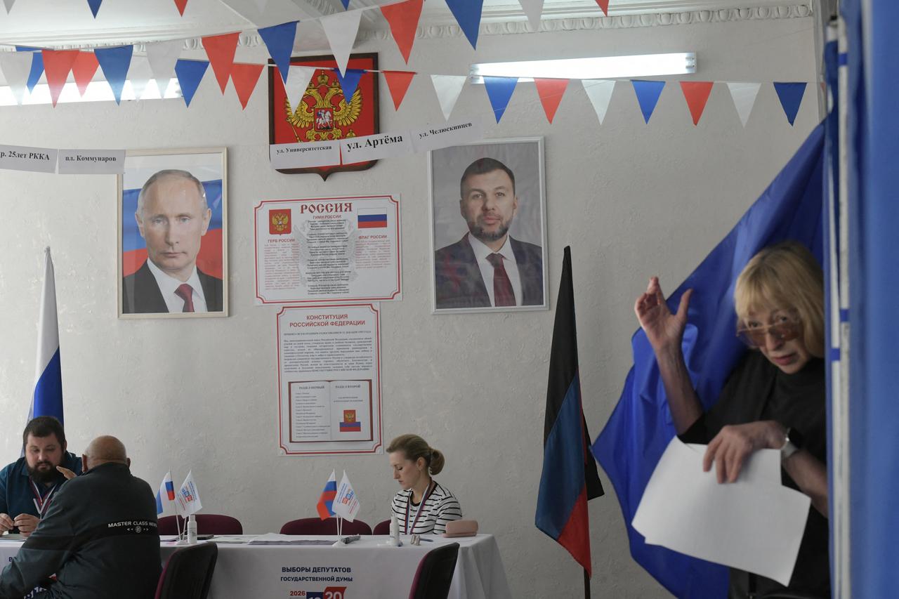 A woman leaves a voting booth during Russia's parliamentary election at a polling station in Donetsk, Russian-controlled Ukraine, on September 20, 2026. (AFP Photo)