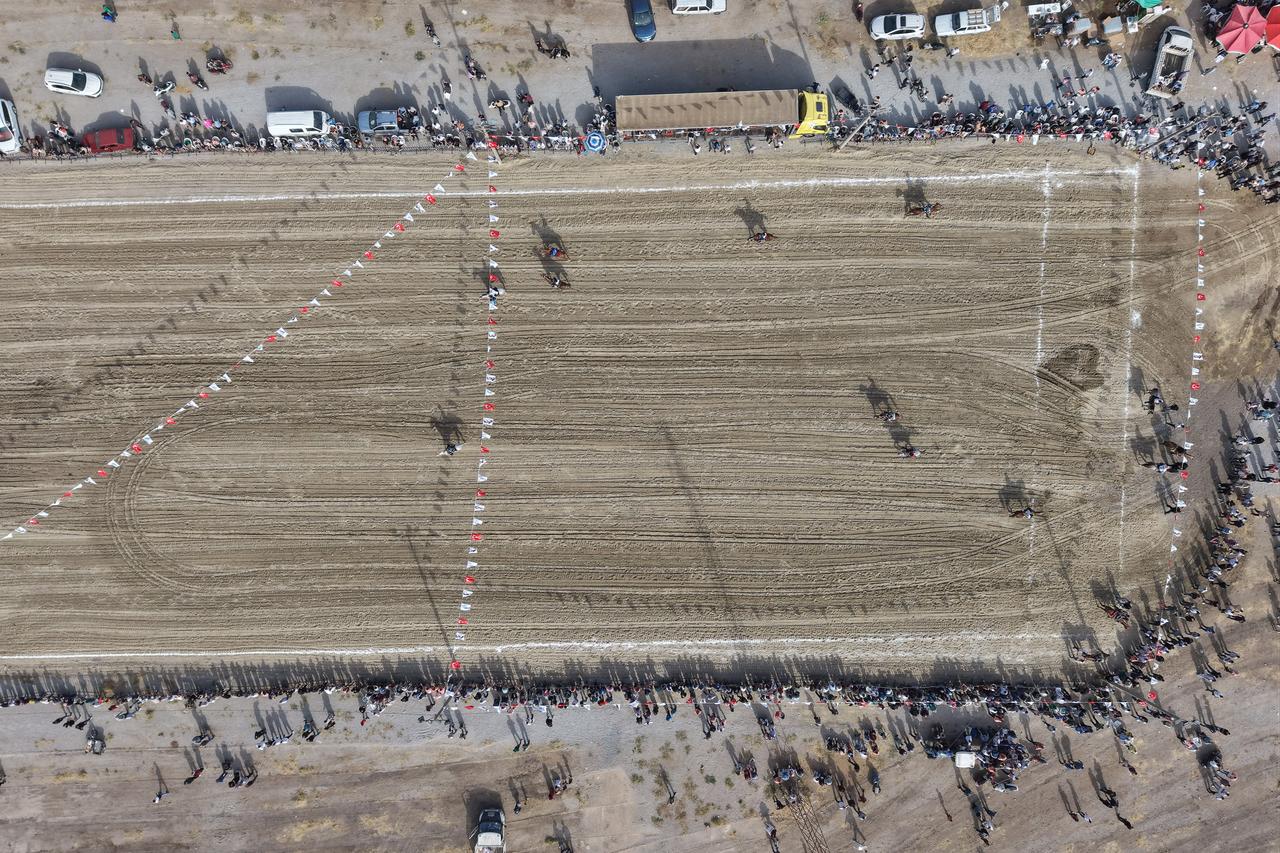 An aerial view shows riders competing in a traditional cirit arena surrounded by spectators in Manisa, Türkiye, Sept. 20, 2026. (AA Photo)