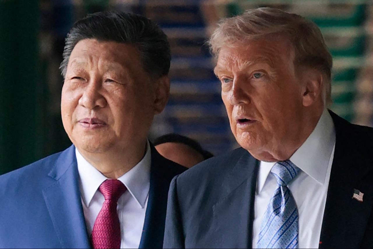US President Donald Trump (R) walks with China’s President Xi Jinping at Zhongnanhai Garden in Beijing on May 15, 2026. (AFP Photo)