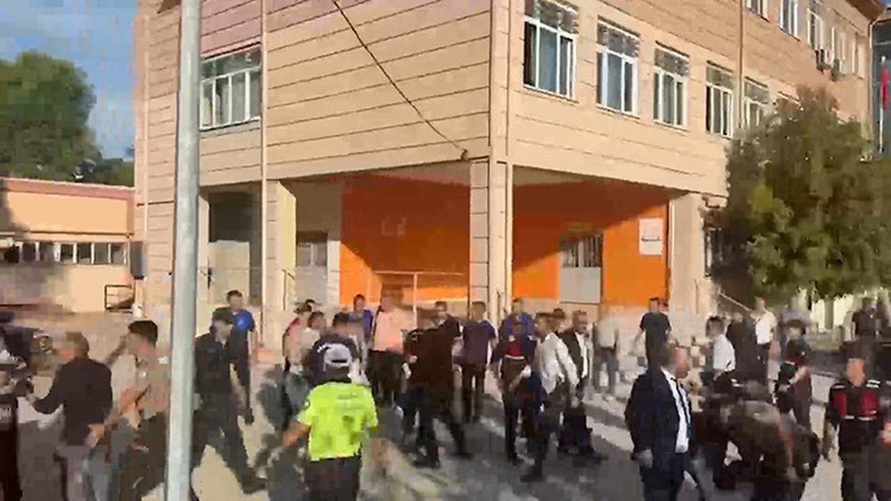 The photo shows a crowd gathering outside the school following the attack in Manisa, Türkiye on Sept. 22, 2026. (IHA Photo)