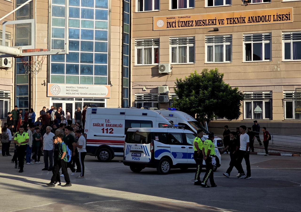 The photo shows police officers and children near the Inci Uzmez Vocational and Technical Anatolian High School in the Turgutlu district of Manisa, Türkiye, Sept. 22, 2026. (AA Photo)