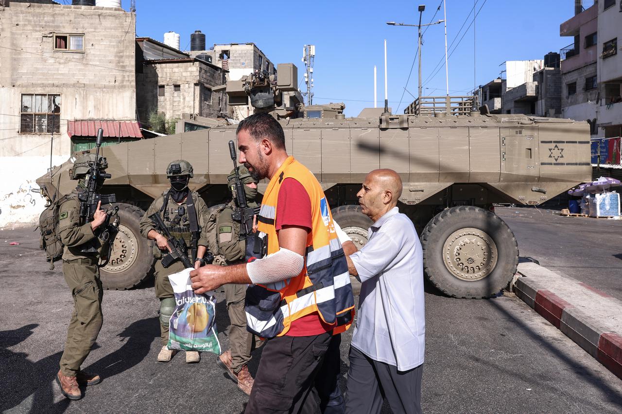 Palestinian Red Crescent members escort a cancer patient being evacuated as Israeli army forces deploy during a military operation at the Ain camp for Palestinian refugees, west of Nablus in the Israeli-occupied West Bank, Sept. 17, 2026. (AFP Photo)
