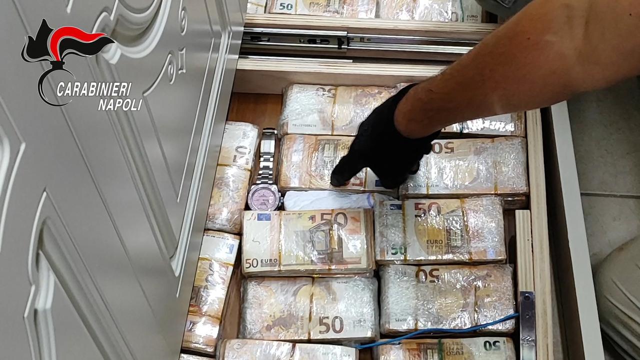 This handout video grab released by the Italian Carabinieri Press Office on September 22, 2026 shows banknotes hidden in a wall during a search by Italian Carabinieri in Caivano near Naples. (AFP Photo)