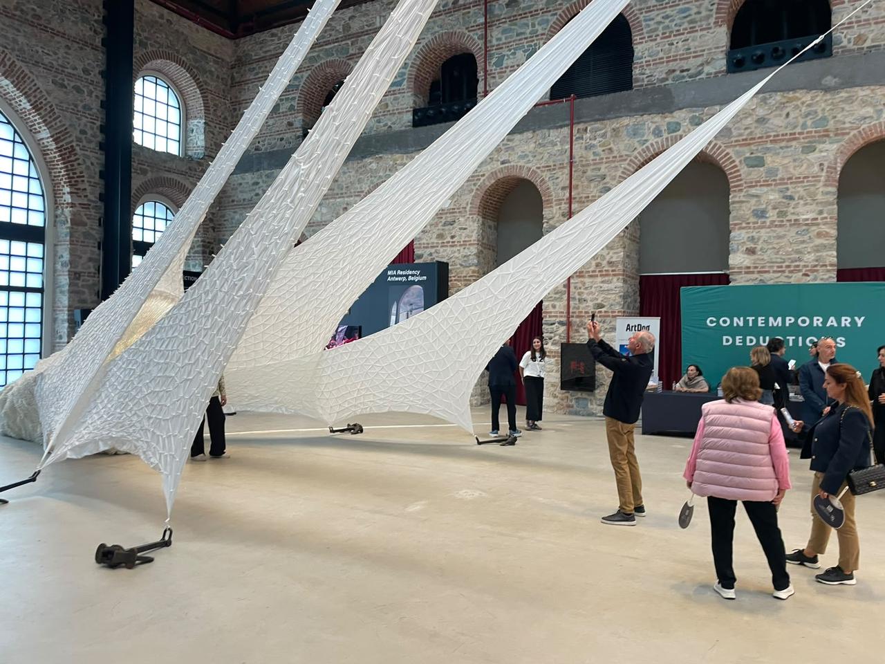 Visitors view a large-scale installation presented at the 21st edition of Contemporary Istanbul at Tersane Istanbul in Türkiye, Sept. 23, 2026. (Photo by Koray Erdogan/Türkiye Today)