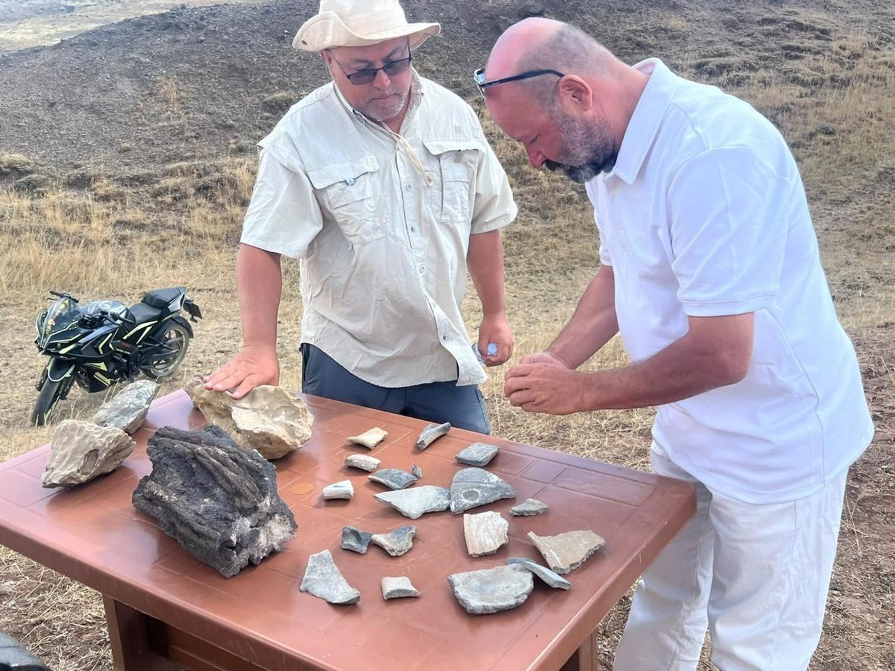 Researchers examine pottery fragments and other material collected during fieldwork at the Durupinar formation near Mount Agri. (IHA Photo)