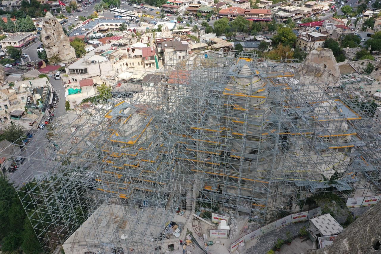 Scaffolding surrounds a fairy chimney during protection work in Goreme, Cappadocia, Türkiye, Sept. 24, 2026. (IHA Photo)