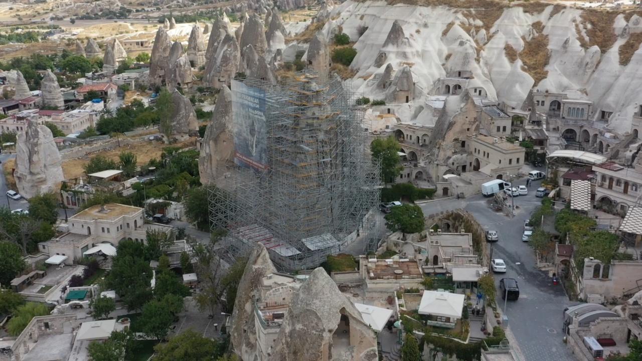 An aerial view shows a fairy chimney covered in scaffolding during protection work in Goreme, Cappadocia, Türkiye, Sept. 24, 2026. (IHA Photo)