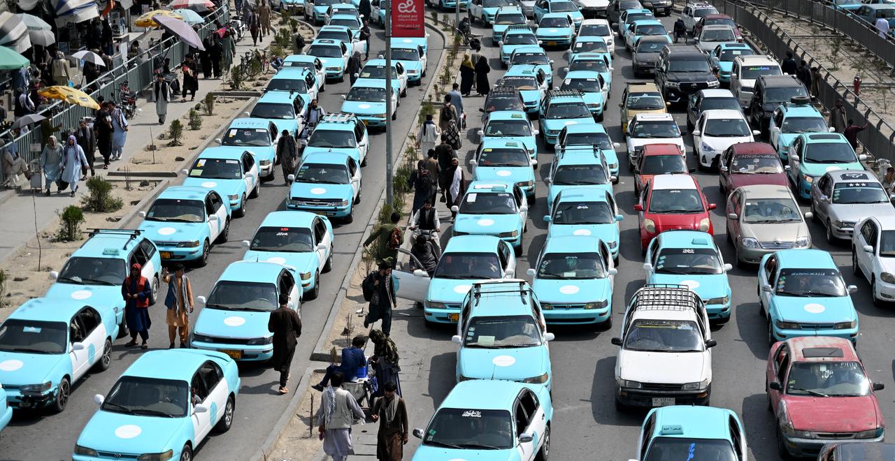 Commuters riding blue taxis wait in a traffic jam in Kabul on September 14, 2026. (AFP Photo)