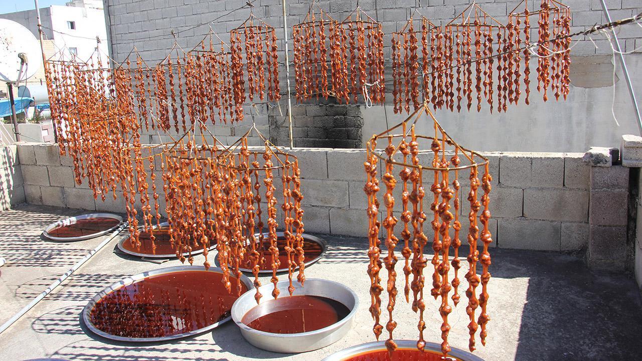 Rows of walnut sucuk hang to dry, showcasing different shades created during the traditional preparation process. (Adobe Stock Photo)