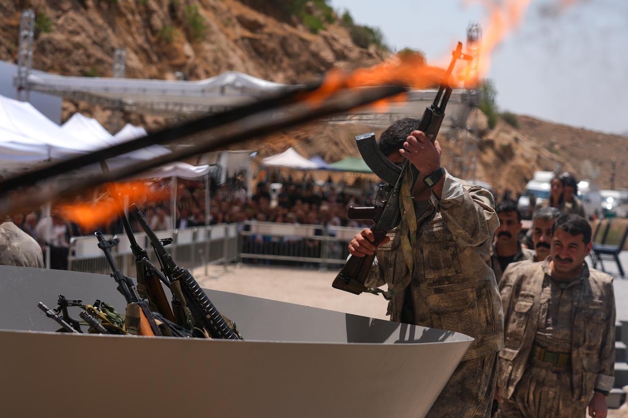The first group of PKK terrorists lays down and destroys their weapons in Sulaymaniyah, northern Iraq, on July 11, 2025. (AA Photo)