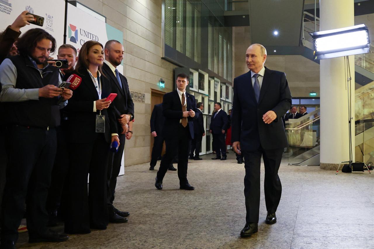 In this pool photograph distributed by the Russian state agency Sputnik, Russia's President Vladimir Putin meets with the media during the International United Cultures Forum at the Mariinsky Theatre in Saint Petersburg on September 25, 2026. (Photo by Sputnik / AFP)