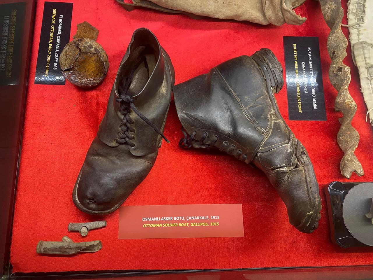 An authentic Ottoman soldier's boot against a red velvet display background; it’s a genuine relic from the Gallipoli front of 1915. (Photo via Türkiye Today team/Feiza Jdidi)
