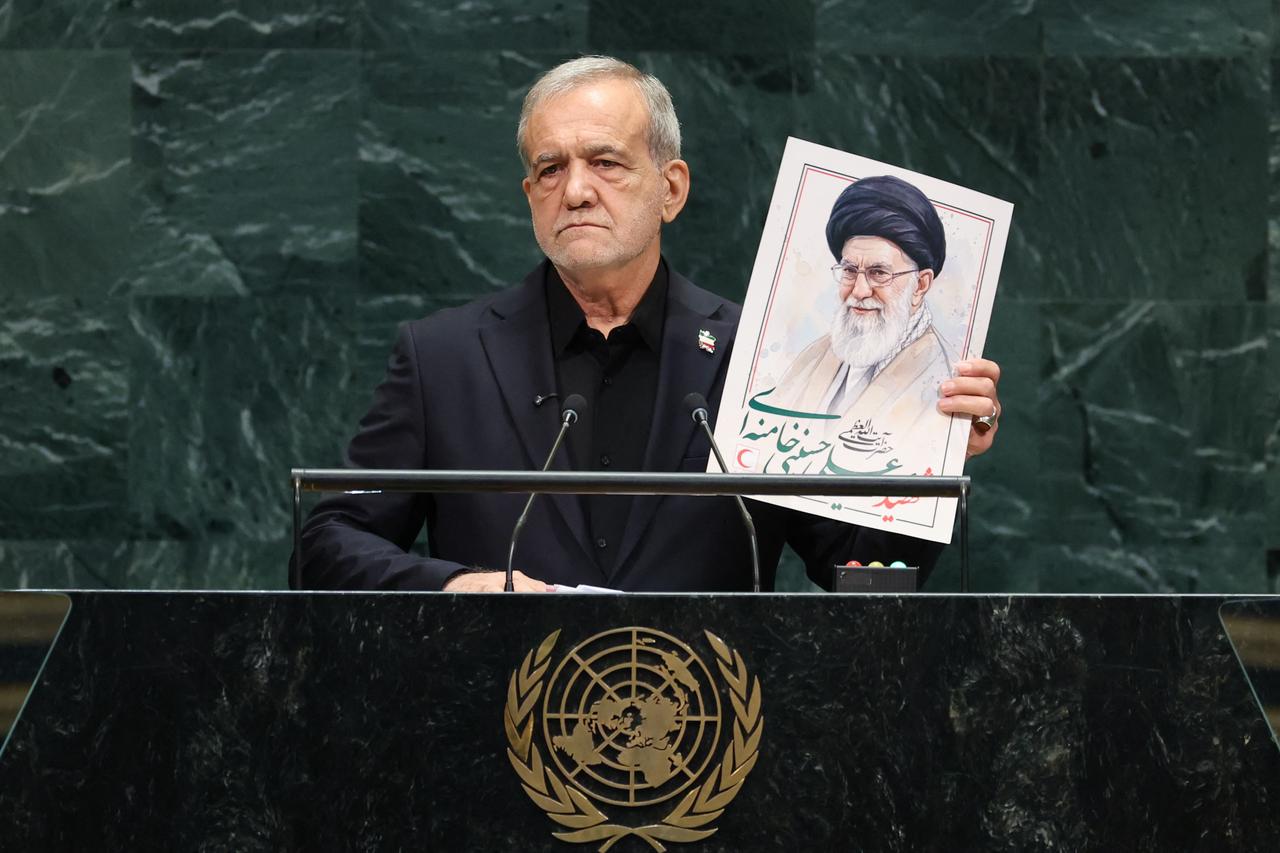 Iran's President Masoud Pezeshkian speaks as he holds a picture of Ali Khamenei, former Supreme Leader of Iran, during the 81st United Nations General Assembly at the United Nations Headquarters in New York, on September 23, 2026. (AFP Photo)