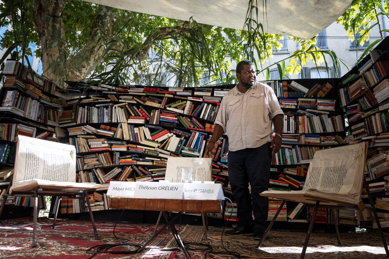 A participant stands before bookshelves during a literary event at Les Correspondances de Manosque in Manosque, France, Sept. 24, 2026. (AFP Photo)