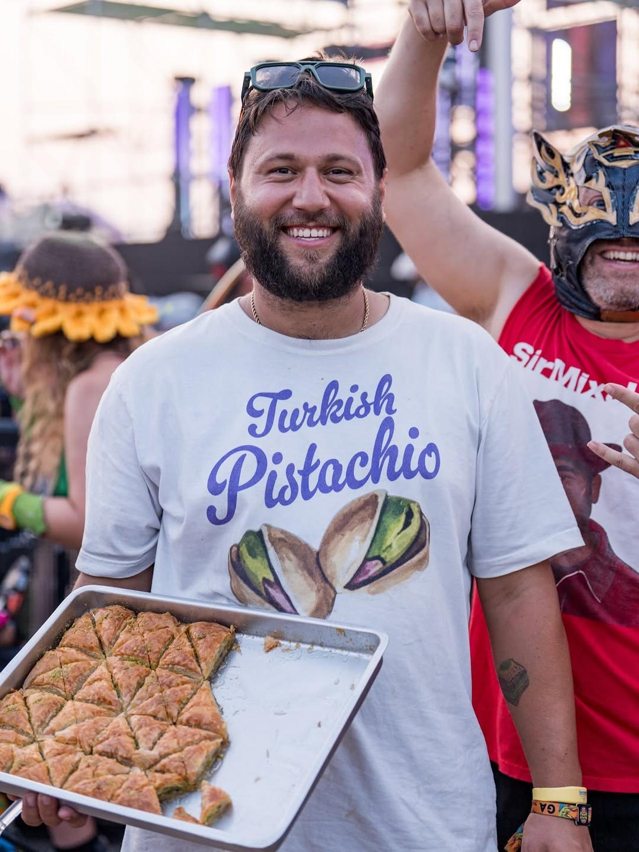 Good Baklava founder Roy Donk with a tray of baklava during the Elements Music & Arts Festival in the US in Aug. 2026. (Photo via Instagram/@good_baklava)