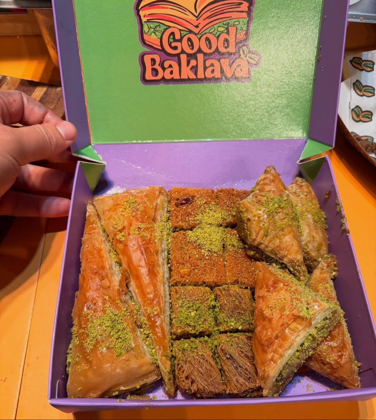 A person holds a package of Good Baklava with various types of Turkish baklava. (Photo via Instagram/@good_baklava)