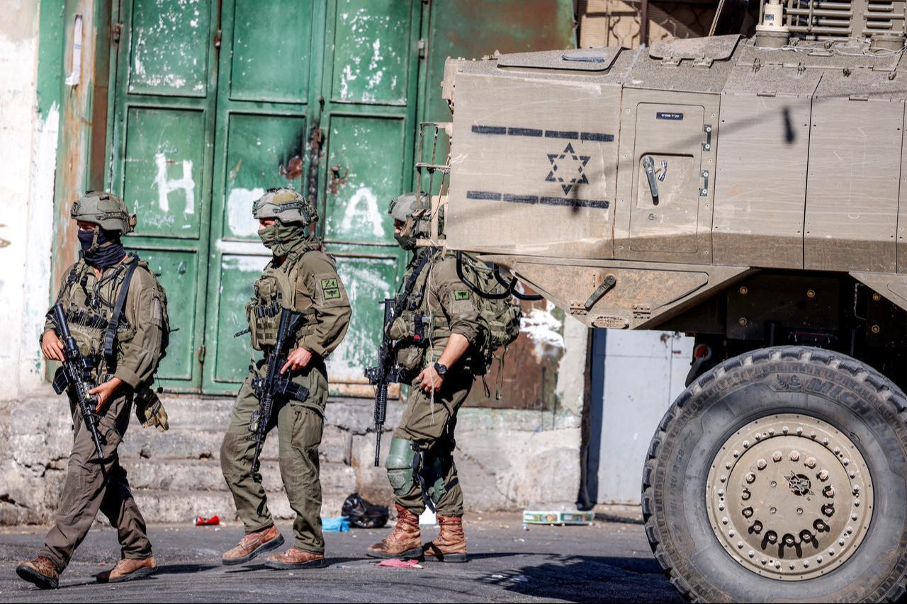 Israeli army soldiers walk near one of their deployed vehicles during a military operation at the entrance of the Ain camp for Palestinian refugees, west of Nablus in the Israeli-occupied West Bank, Sept. 17, 2026. (AFP Photo)