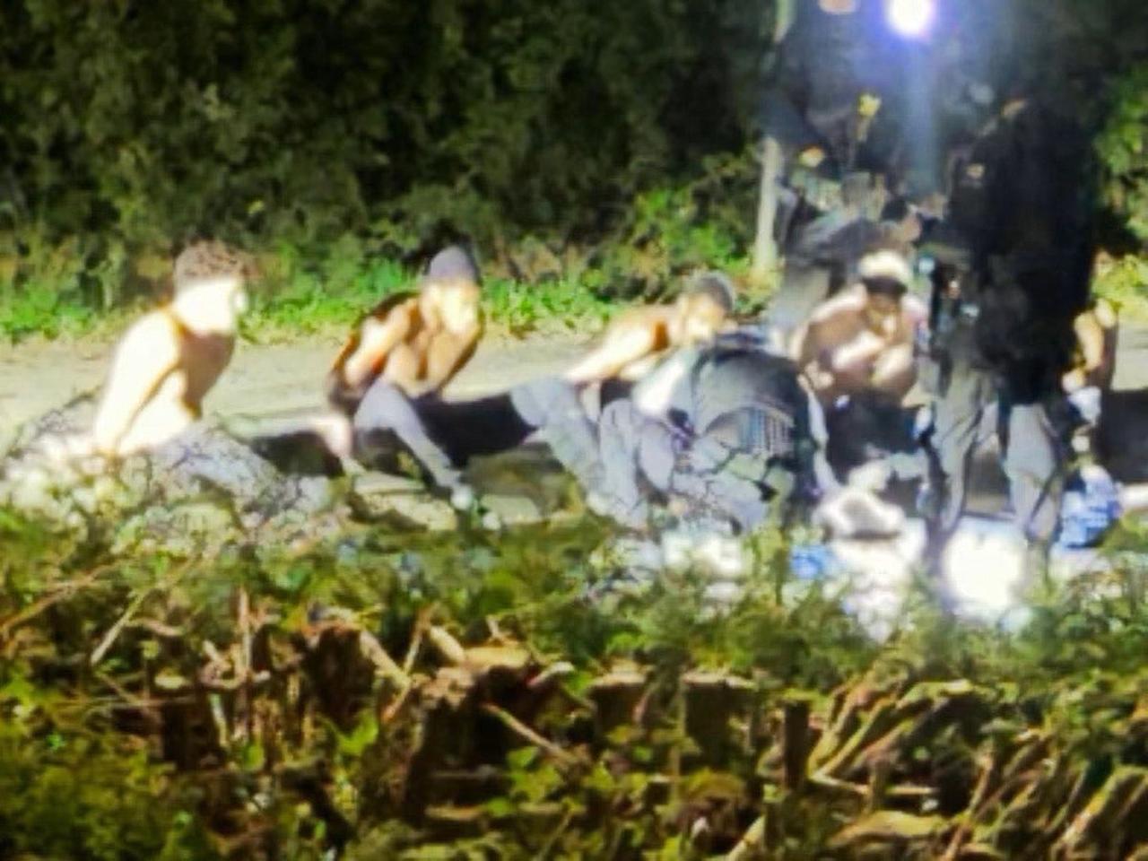 The photo reportedly shows the group of suspects being filmed as they were arrested near RAF Fairford, UK. (Photo via The Telegraph)