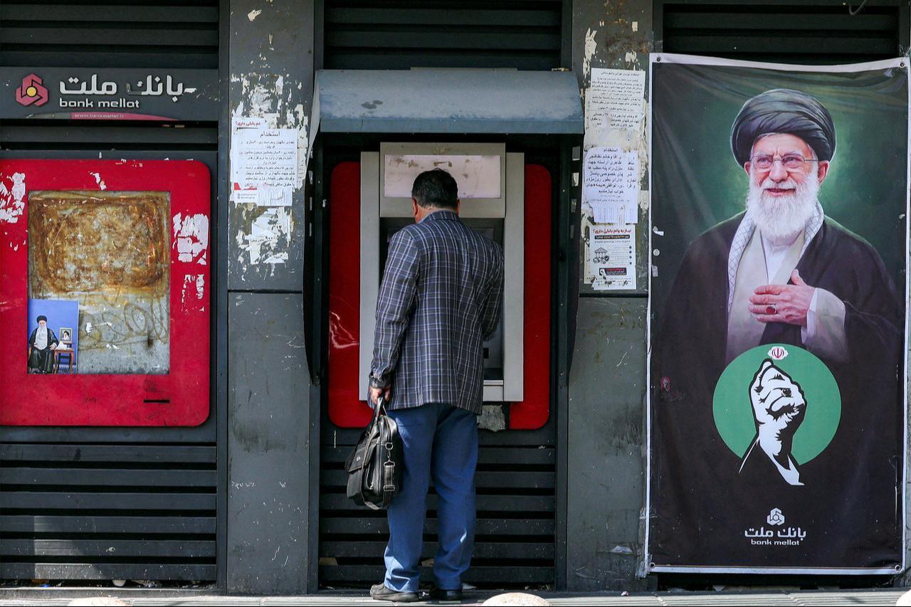A man uses an automated teller machine (ATM) from Bank Mellat in Tehran on September 7, 2026. (AFP Photo)