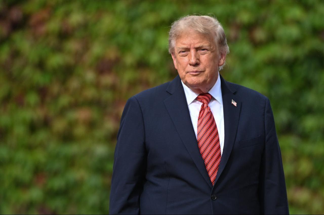 U.S. President Donald Trump pauses as he walks alone along an ivy-covered wall during his final departure from Aras an Uachtarain on Sept. 12, 2026, in Dublin, Ireland. (AA Photo)