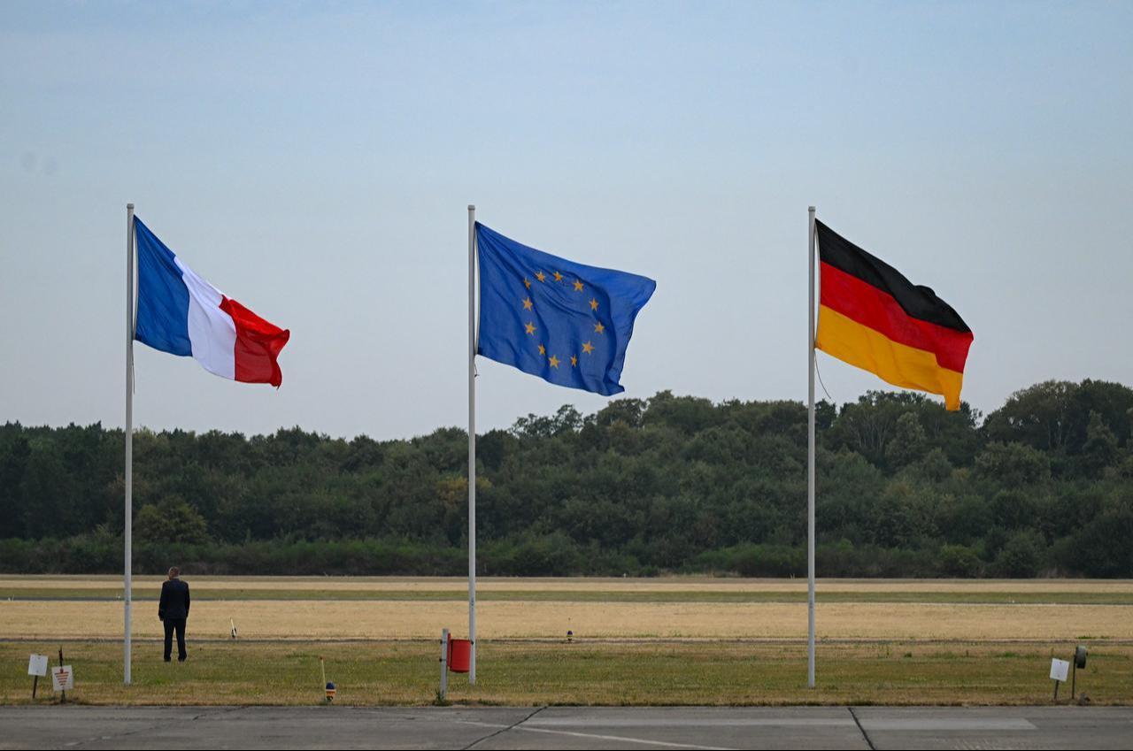 (L-R) The French, European, and German flags flutter in the wind at Noervenich Air Base in Noervenich, western Germany, on July 17, 2026. (AFP Photo)