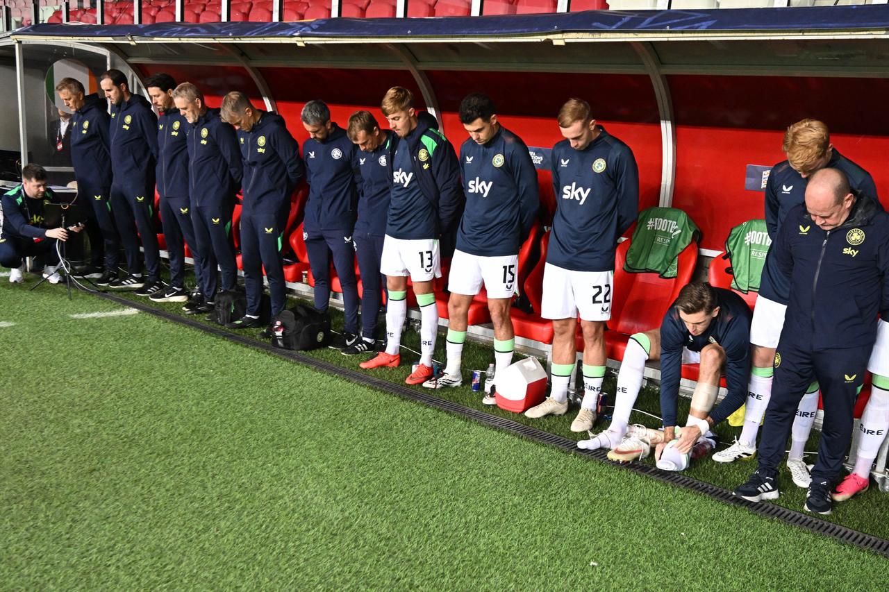 Members of the Republic of Ireland team stand with their heads bowed at the bench as the Israeli national anthem is played before the UEFA Nations League Group B3 between Israel and Republic of Ireland in Debrecen, Hungary on September 27, 2026. (AFP PHoto)