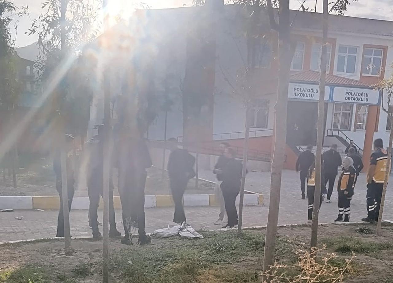 The photo shows a group of people standing in the schoolyard after a student was caught at a school, who was carrying a long-barreled firearm in Tusba, Van, Sept. 28, 2026. (IHA Photo)