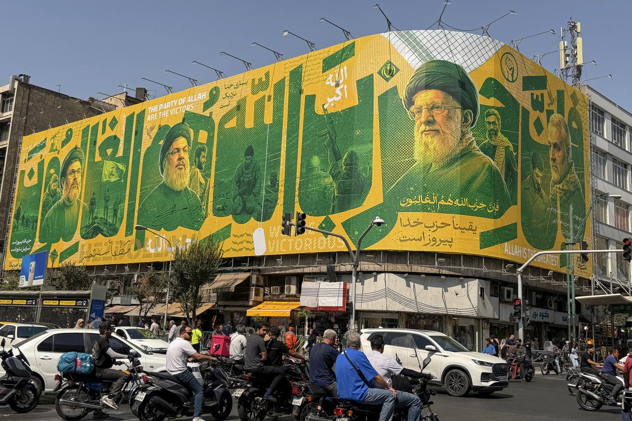 Iranians commute past a billboard depicting slain Lebanese Hezbollah leader Hassan Nasrallah (L) and Iran's slain supreme leader Ayatollah Ali Khamenei (2nd R) in Tehran on September 27, 2026, on the second anniversary of Nasrallah's killing in a major strike by Israel on Beirut's southern suburbs. (AFP Photo)